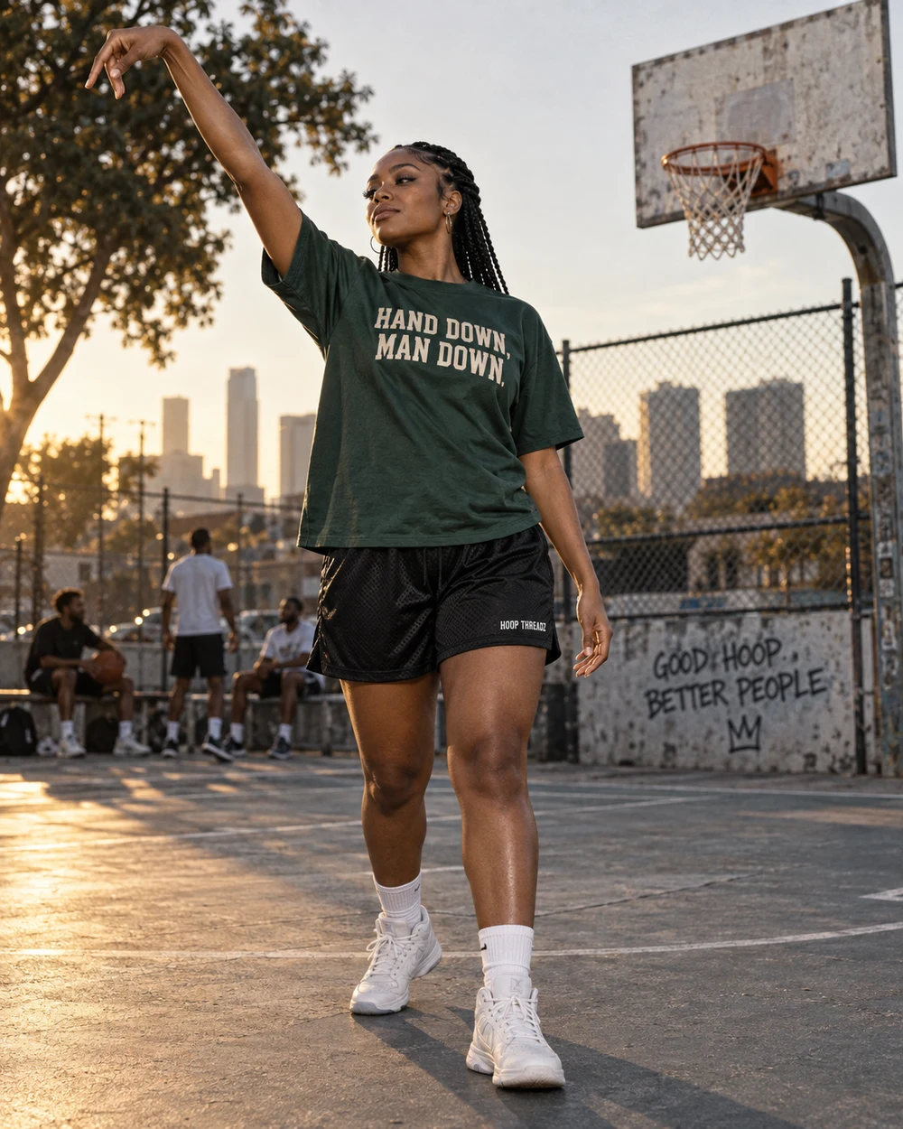 Black woman wearing Hand Down Man Down Hoop Threadz apparel on an outdoor court